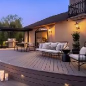 Custom timber deck and outdoor entertaining area with modern seating, pergola and warm ambient lighting.
