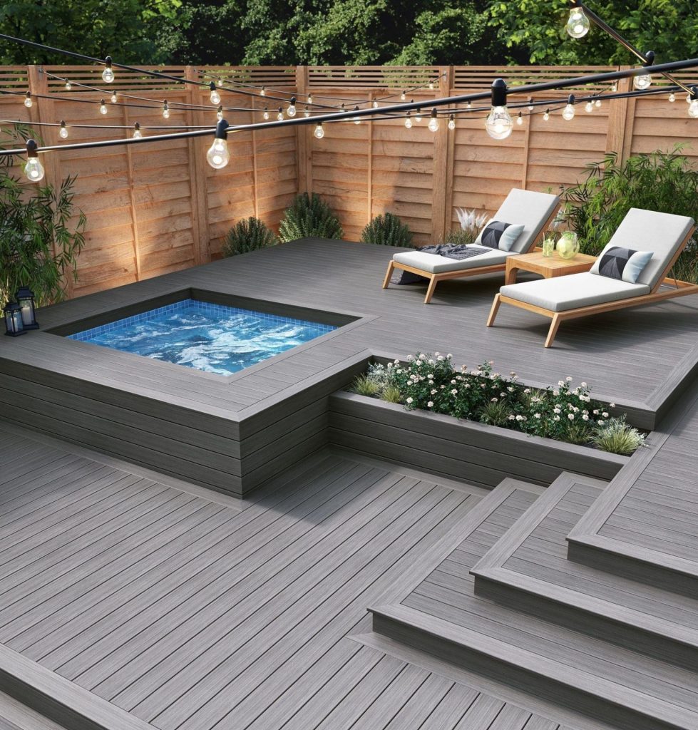 Custom composite deck with built-in spa, raised garden beds, lounge seating and outdoor lighting.